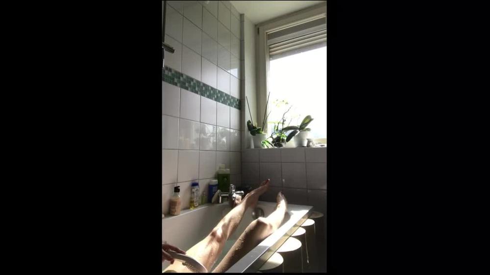 Snapchat story. Cute natural girl takes a bath by the window.