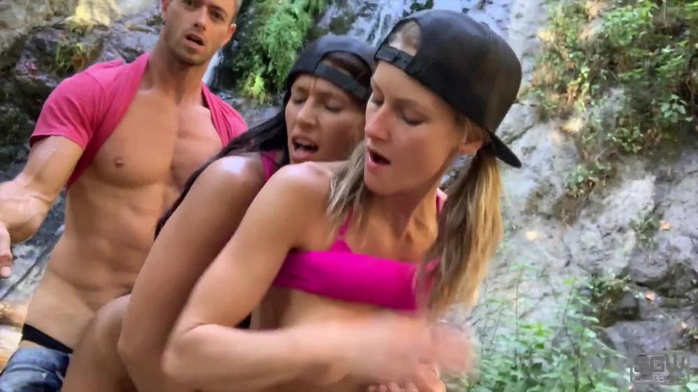 Hot guy and 2 sexy girls have a threesome next to a waterfall