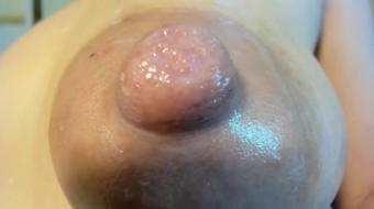 Teasing her breasts, she sucks her nipples
