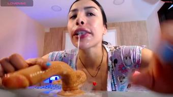 Youthful nymph revels in massive dildo, chin slick with sali