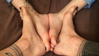 Oiling feet , sisters together