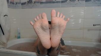 wet wrinkled feet in soap foam - June 04, 2021