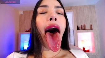 A Latina's Tongue Pleasures a Saliva-Coated Dildo