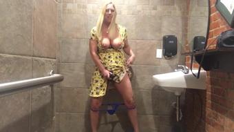 Horny MILF vibrates pussy in bar restroom!