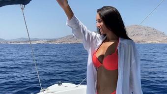 Tanned brunette masturbates on a boat